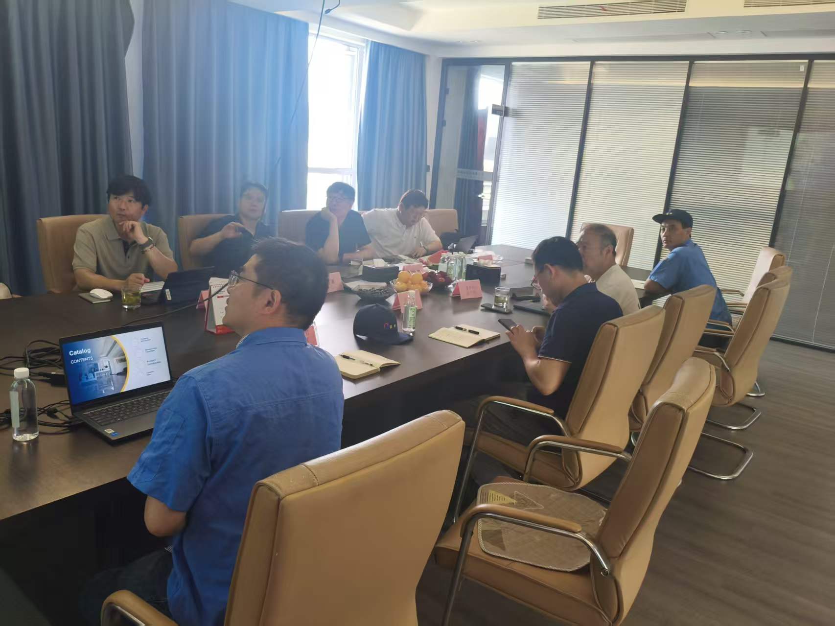 Representatives from HI AIR and honryheatex discussing HVAC products in a meeting room