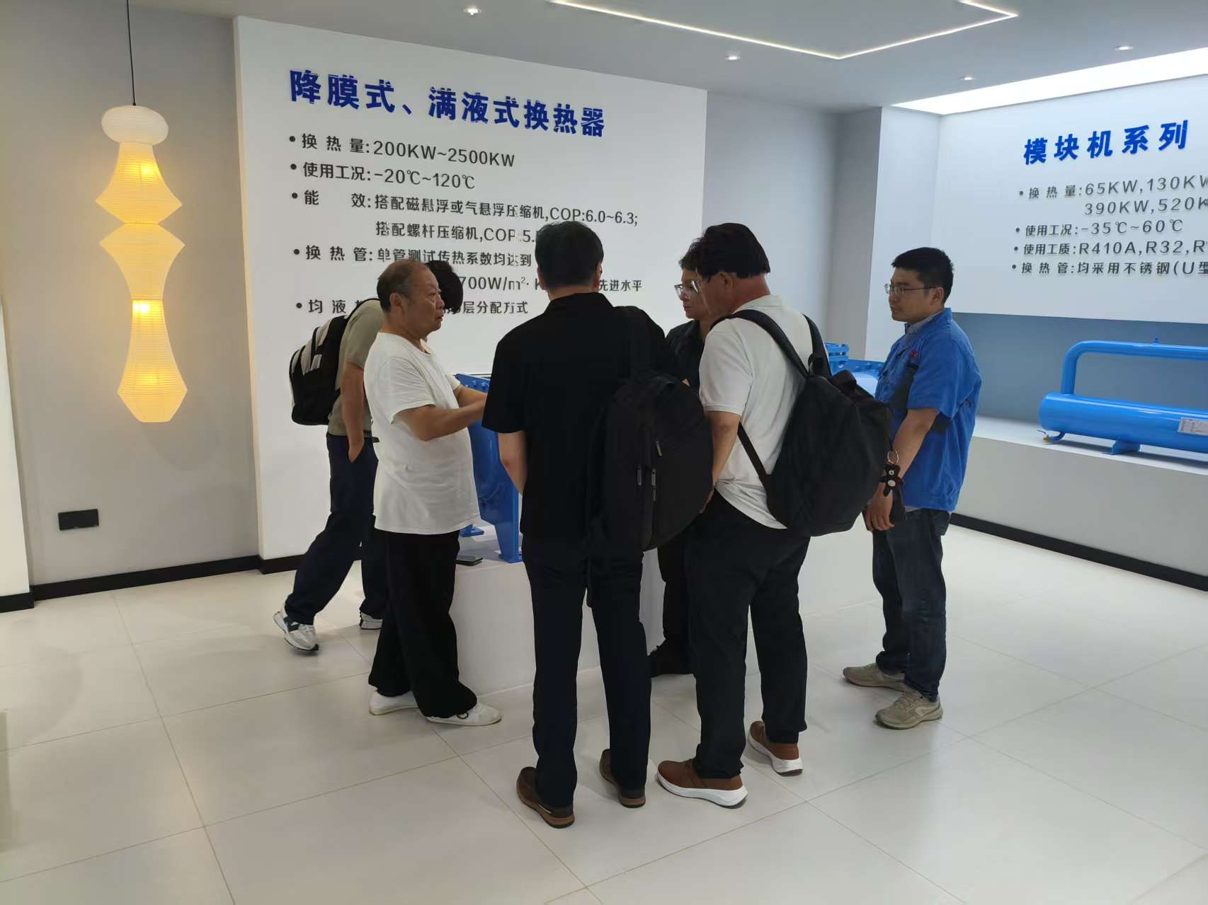 HI AIR representatives viewing modular chiller units in the honryheatex showroom